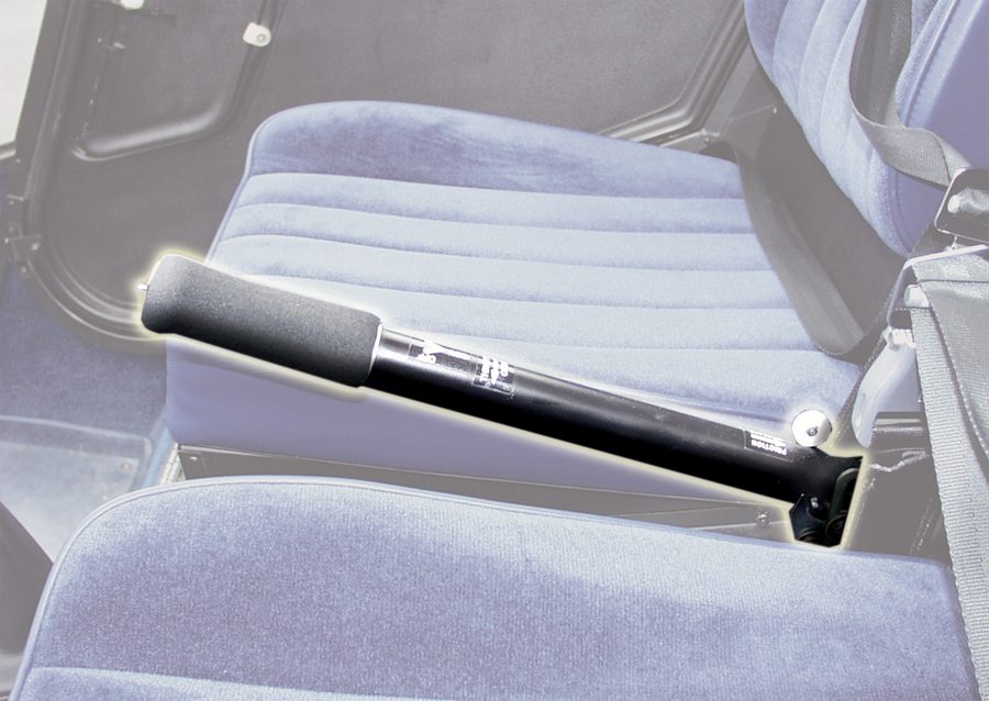 Photograph of a helicopter cyclic stick rising from the floor between the seats.